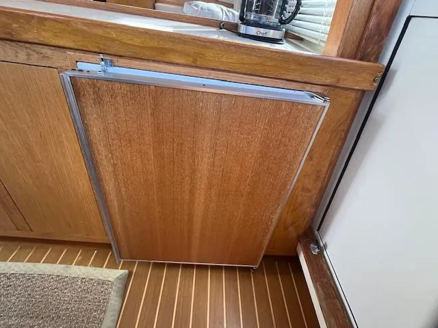  Yacht Photos Pics Wooden cabinet door in Mainship 430 Trawler, 2000 model, with sleek design and natural finish.