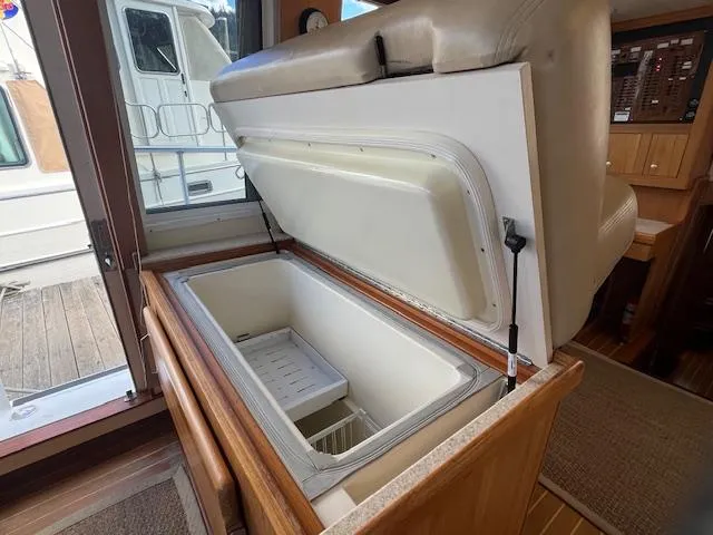 Yacht Photos Pics Interior view of a 2000 Mainship 430 Trawler with an open storage compartment.