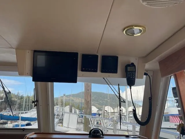  Yacht Photos Pics Interior view of a 2000 Mainship 430 Trawler with navigation equipment and marina background.