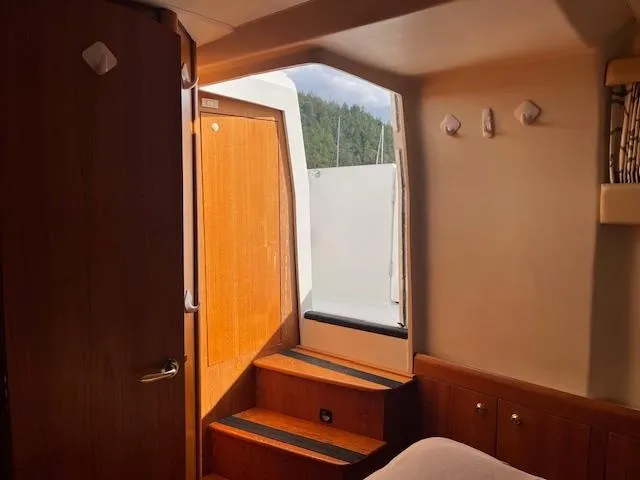  Yacht Photos Pics Interior view of 2000 Mainship 430 Trawler cabin with wooden steps and door.