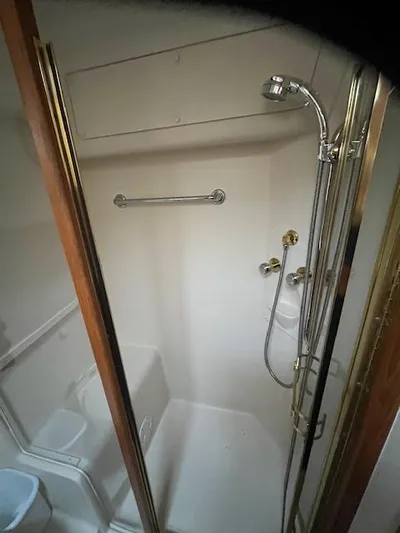  Yacht Photos Pics Shower area in 2000 Mainship 430 Trawler with chrome fixtures and glass door.