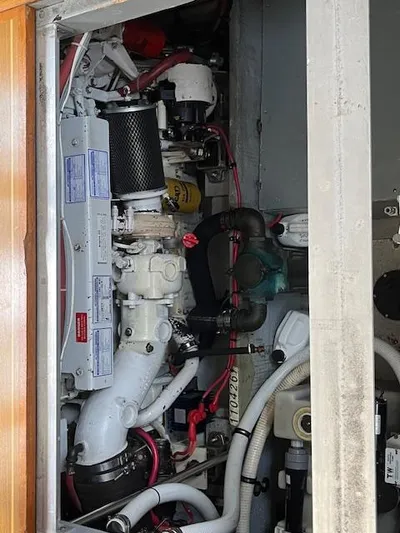  Yacht Photos Pics Engine compartment of a 2000 Mainship 430 Trawler, showcasing mechanical components and wiring.