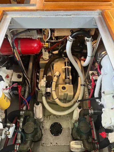  Yacht Photos Pics Engine room of a 2000 Mainship 430 Trawler, showcasing mechanical components and wiring.