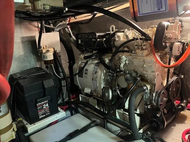  Yacht Photos Pics Engine room of 2000 Mainship 430 Trawler with visible battery and machinery components.