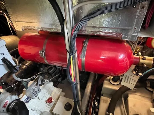  Yacht Photos Pics Engine room of 2000 Mainship 430 Trawler with red fire extinguisher tank.