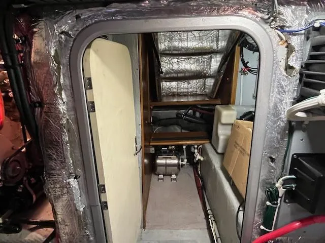  Yacht Photos Pics Engine room of a 2000 Mainship 430 Trawler, showing equipment and insulation.