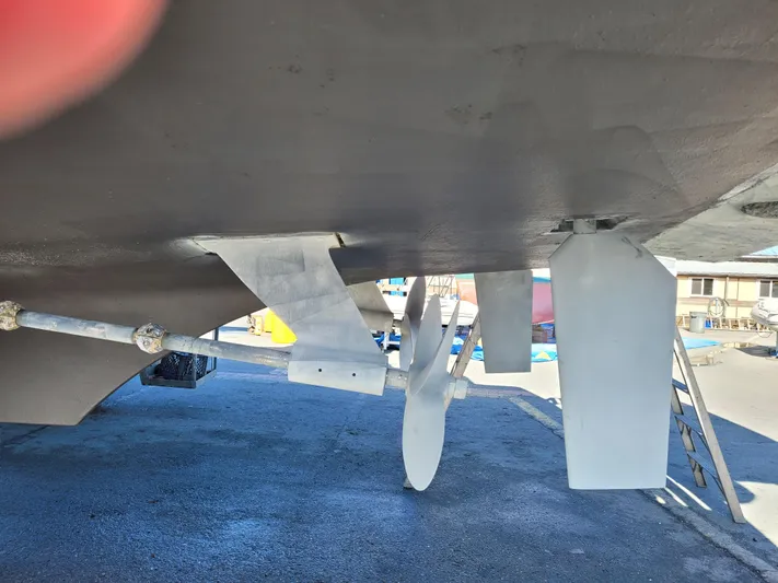  Yacht Photos Pics Underside view of a 2000 Mainship 430 Trawler, showcasing propeller and rudder.