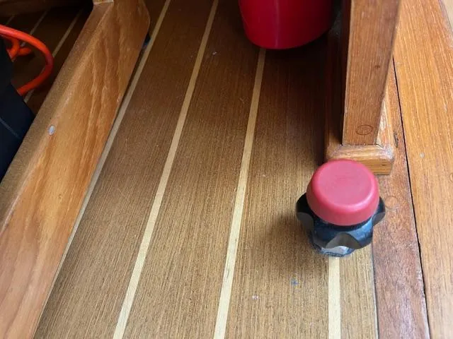  Yacht Photos Pics Wooden deck of 2000 Mainship 430 Trawler with red knob and storage compartment.