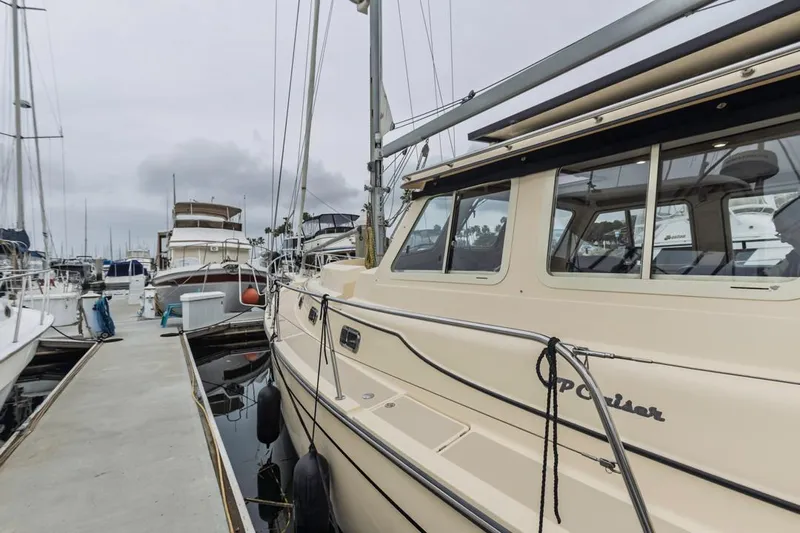 Seeker Yacht Photos Pics 2007 Island Packet SP Cruiser docked at marina, overcast sky.