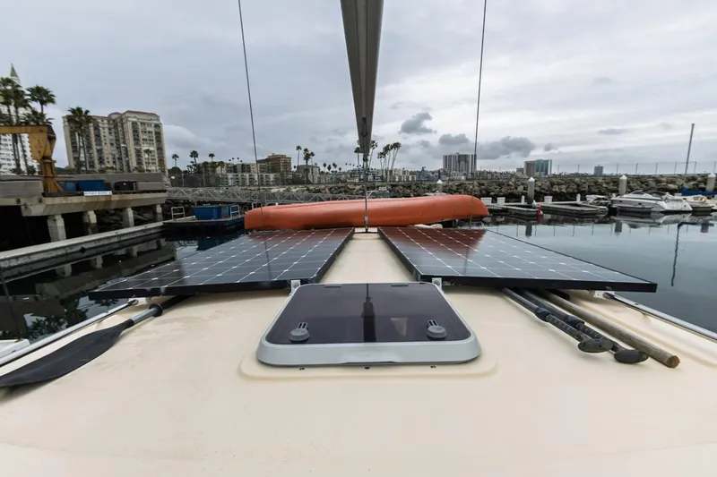 Seeker Yacht Photos Pics 2007 Island Packet SP Cruiser with solar panels docked in a marina.