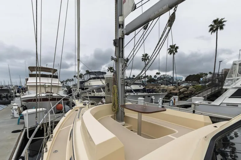 Seeker Yacht Photos Pics 2007 Island Packet SP Cruiser docked in a marina, surrounded by other boats and palm trees.