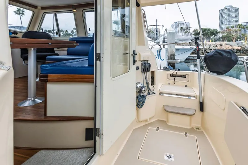 Seeker Yacht Photos Pics 2007 Island Packet SP Cruiser interior with seating and table, docked at marina.