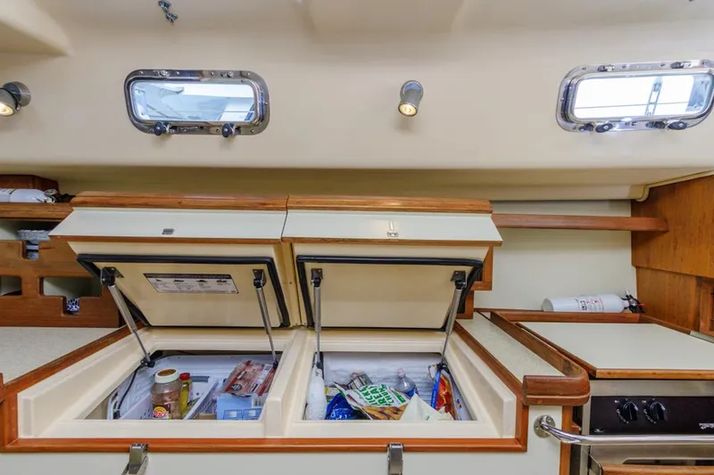 Seeker Yacht Photos Pics 2007 Island Packet SP Cruiser galley with open storage compartments and windows.
