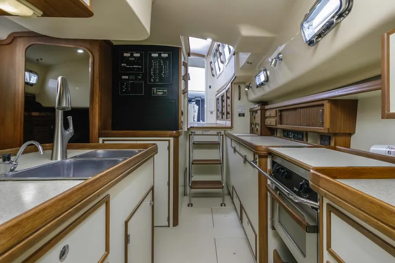 Seeker Yacht Photos Pics 2007 Island Packet SP Cruiser interior with modern kitchen, wood accents, and ample natural light.