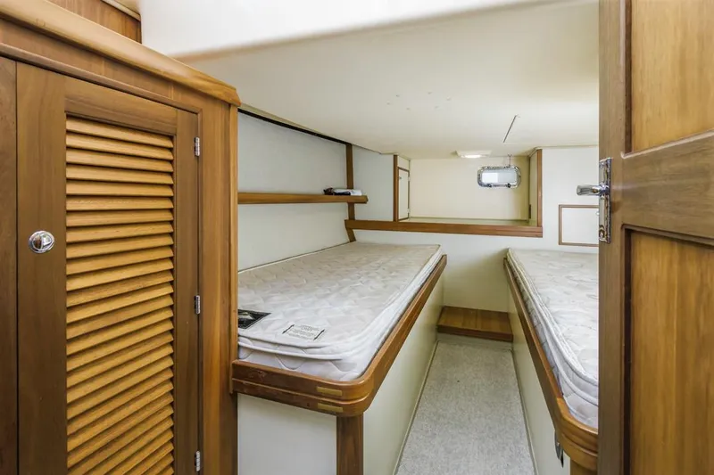 Seeker Yacht Photos Pics 2007 Island Packet SP Cruiser cabin with twin beds and wooden cabinetry.