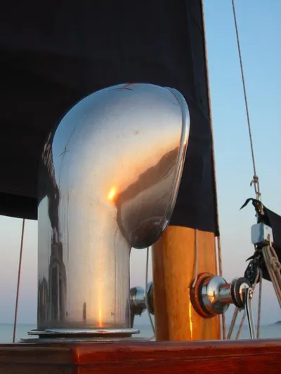 Sea Prince Yacht Photos Pics Close-up of a 1953 Abeking & Rasmussen Motor Sailer deck detail at sunset.