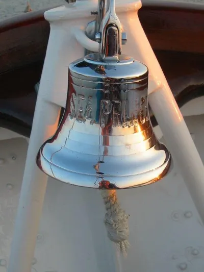 Sea Prince Yacht Photos Pics Shiny bell on 1953 Abeking & Rasmussen Motor Sailer, reflecting sunlight.