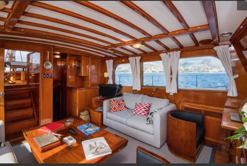 Sea Prince Yacht Photos Pics Luxurious 1953 Abeking & Rasmussen motor sailer interior with wooden decor and ocean view.
