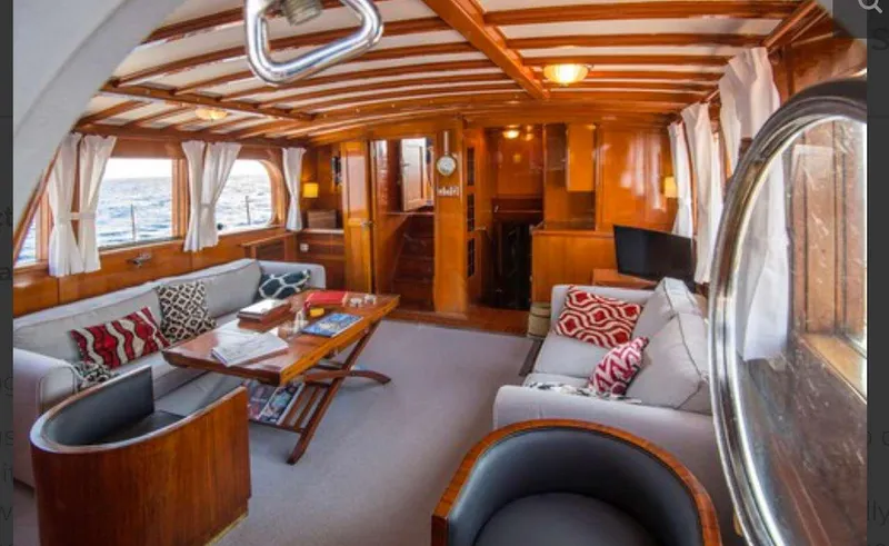 Sea Prince Yacht Photos Pics Luxurious 1953 Abeking & Rasmussen motor sailer interior with wooden decor and comfortable seating.