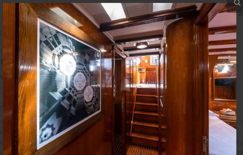 Sea Prince Yacht Photos Pics Interior of 1953 Abeking & Rasmussen Motor Sailer with wooden paneling and staircase.