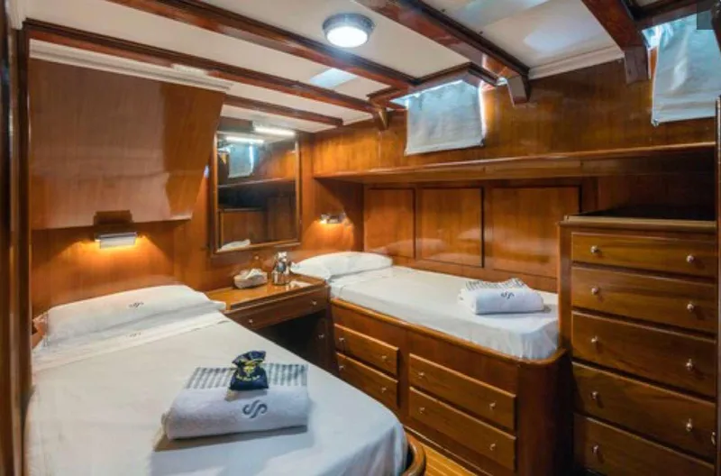 Sea Prince Yacht Photos Pics Luxurious wooden cabin interior of 1953 Abeking & Rasmussen Motor Sailer with twin beds.