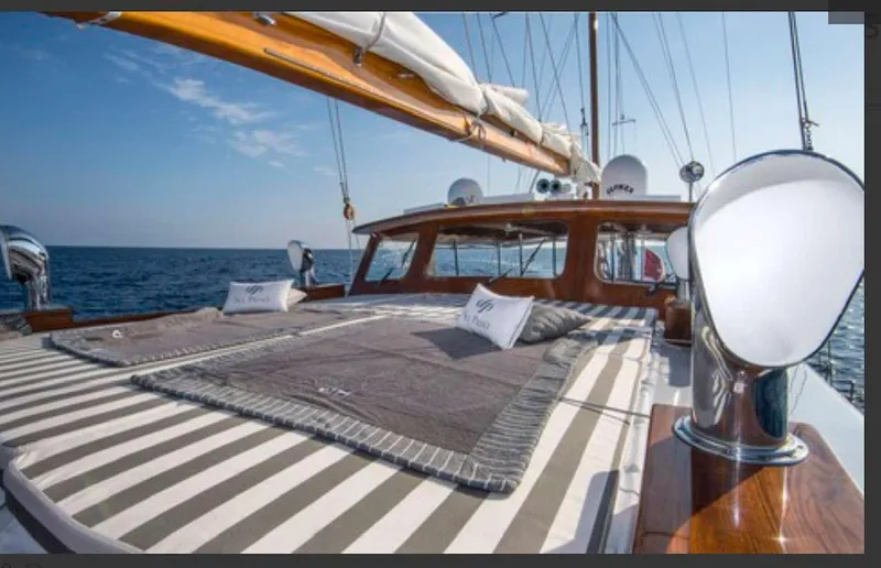 Sea Prince Yacht Photos Pics Luxurious 1953 Abeking & Rasmussen Motor Sailer with striped deck cushions, sailing on open sea.