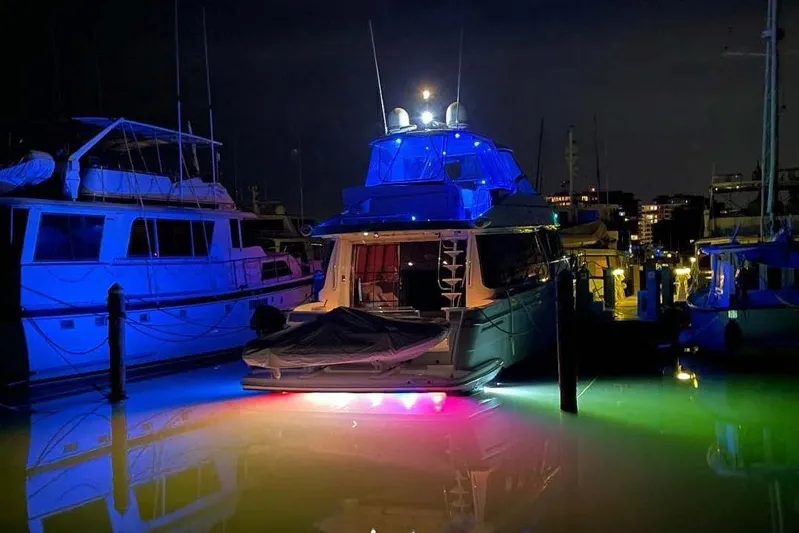  Yacht Photos Pics Illuminated 2004 Carver 570 Voyager Pilothouse yacht docked at night with colorful lights.