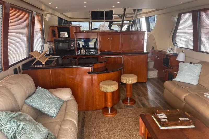  Yacht Photos Pics Luxurious interior of 2004 Carver 570 Voyager Pilothouse with elegant wood finishes.
