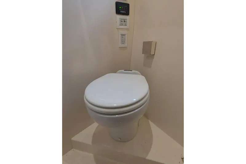  Yacht Photos Pics Toilet in 2004 Carver 570 Voyager Pilothouse yacht bathroom, featuring modern controls.