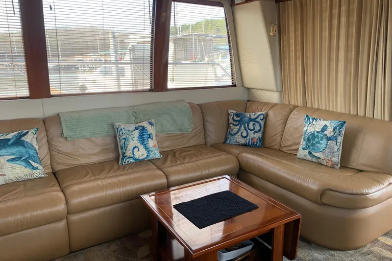  Yacht Photos Pics Luxurious interior of 2004 Carver 570 Voyager Pilothouse with leather seating and nautical-themed pillows.