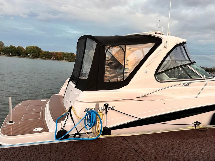  Yacht Photos Pics 2007 Four Winns 378 Vista boat docked by a serene lake.