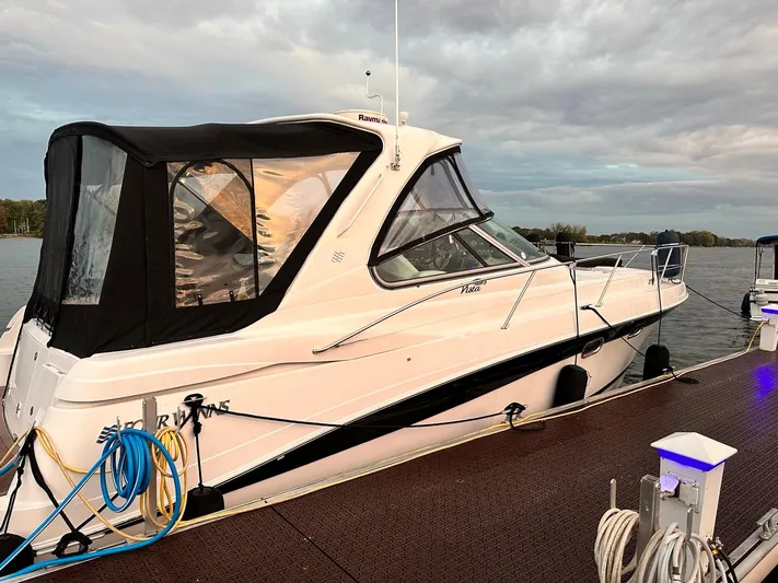  Yacht Photos Pics 2007 Four Winns 378 Vista yacht docked, featuring sleek design and black canopy.