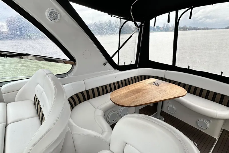  Yacht Photos Pics Interior of 2007 Four Winns 378 Vista yacht with white seating and wooden table.