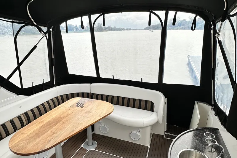  Yacht Photos Pics 2007 Four Winns 378 Vista boat interior with seating and wooden table, overlooking water.