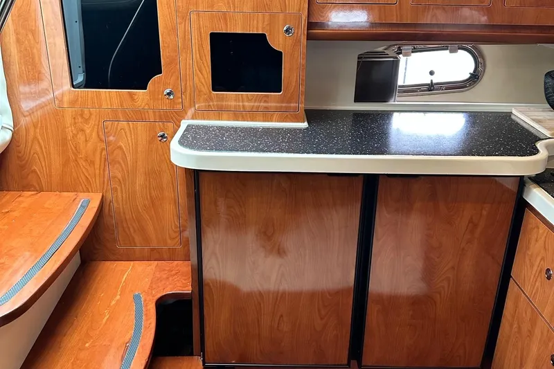  Yacht Photos Pics 2007 Four Winns 378 Vista cabin interior with wood finish and countertop.