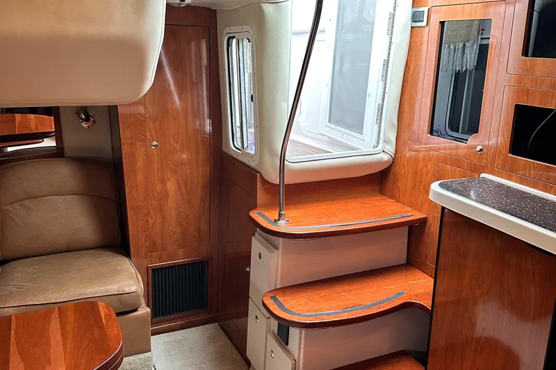  Yacht Photos Pics 2007 Four Winns 378 Vista yacht interior with wooden cabinetry and seating.