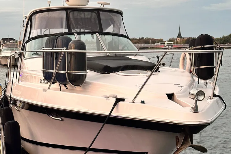  Yacht Photos Pics 2007 Four Winns 378 Vista boat docked on calm water with scenic background.
