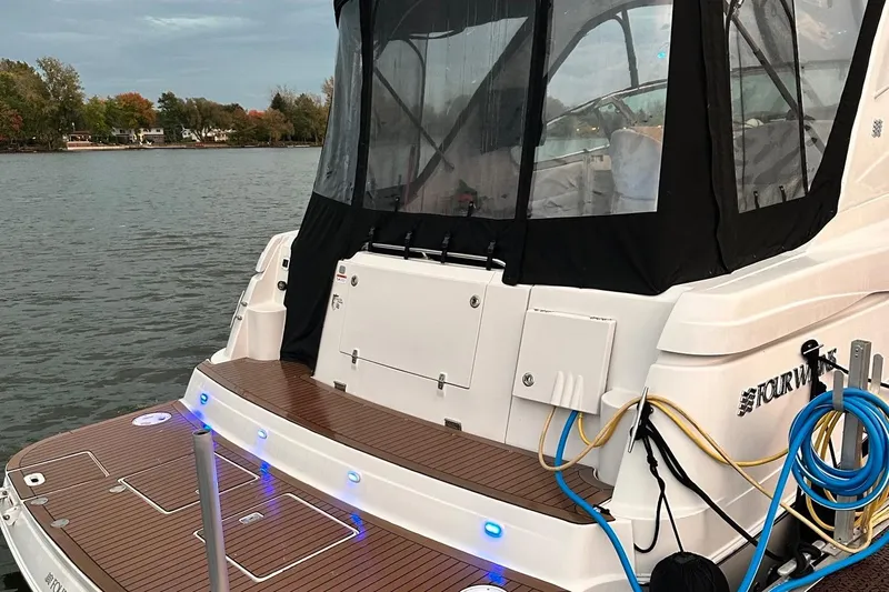  Yacht Photos Pics 2007 Four Winns 378 Vista boat docked on a calm lake with visible deck and canopy.