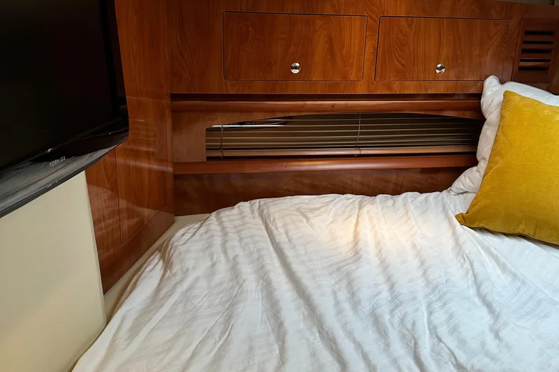  Yacht Photos Pics Interior cabin of 2007 Four Winns 378 Vista with wood paneling and bedding.