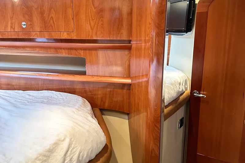  Yacht Photos Pics Interior cabin of 2007 Four Winns 378 Vista yacht with wooden finish and cozy bedding.