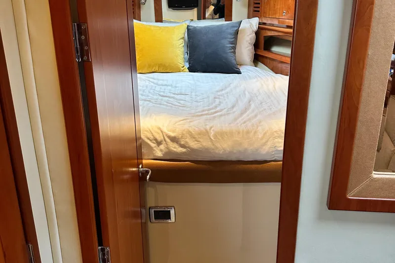  Yacht Photos Pics Interior cabin of 2007 Four Winns 378 Vista with bed and colorful pillows.