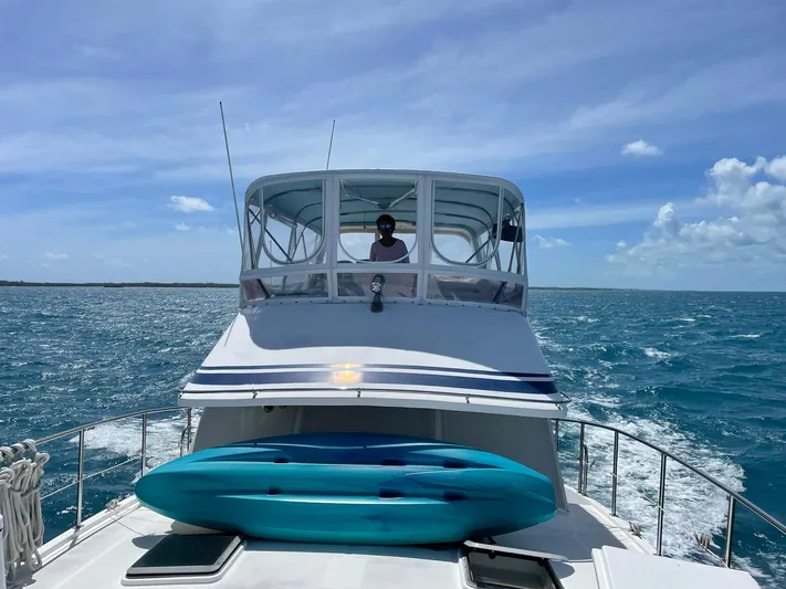 Sea Fever Yacht Photos Pics 1987 Symbol 44 Sun Deck MK II yacht cruising on blue ocean with clear skies.