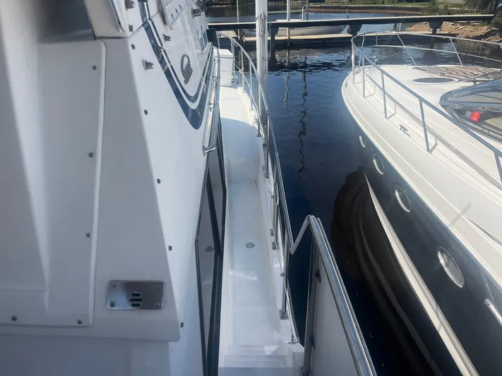 Sea Fever Yacht Photos Pics 1987 Symbol 44 Sun Deck MK II yacht docked, showing side deck and railing.