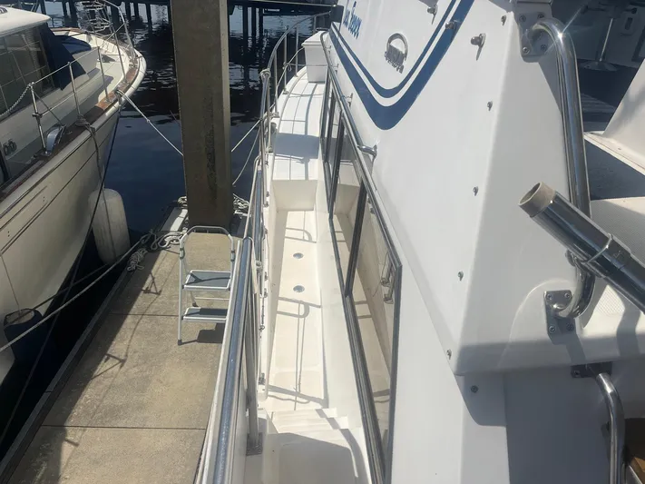 Sea Fever Yacht Photos Pics 1987 Symbol 44 Sun Deck MK II yacht docked at marina, side view.