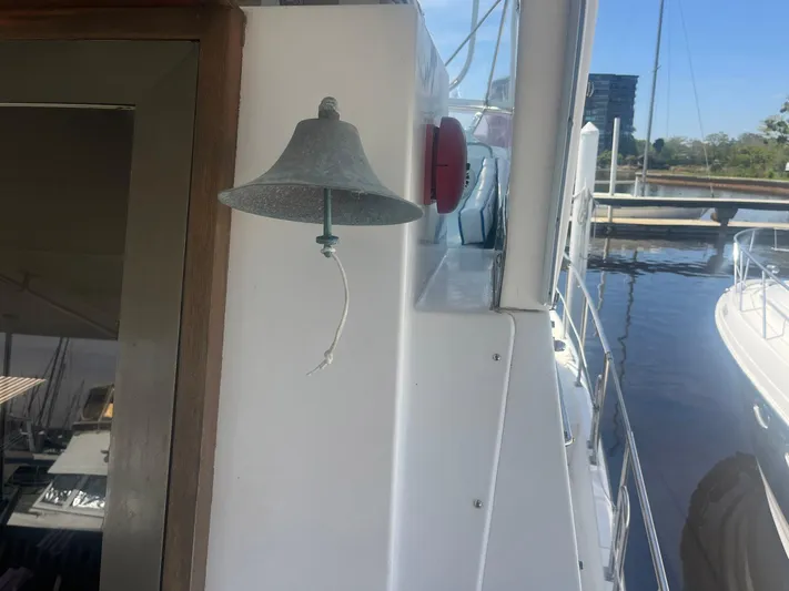 Sea Fever Yacht Photos Pics A bell on the 1987 Symbol 44 Sun Deck MK II yacht, docked by the water.