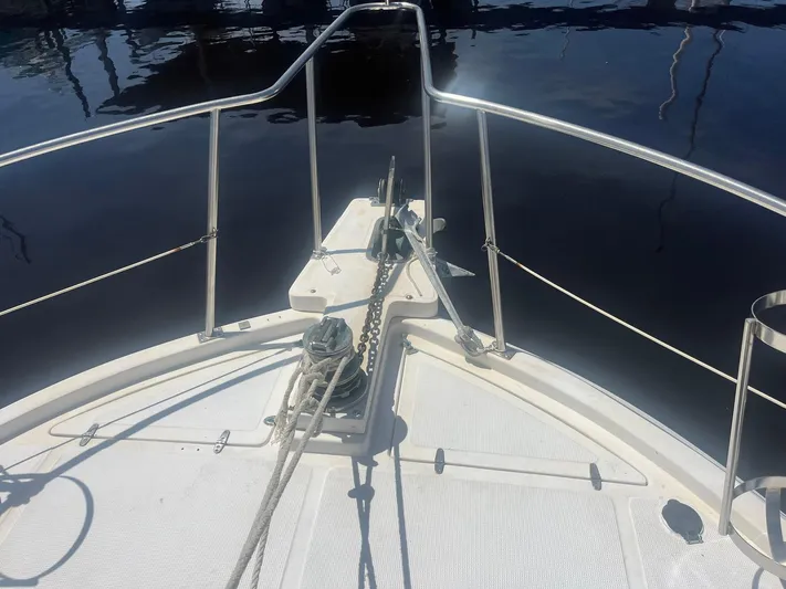 Sea Fever Yacht Photos Pics Bow view of 1987 Symbol 44 Sun Deck MK II yacht with anchor and railing.
