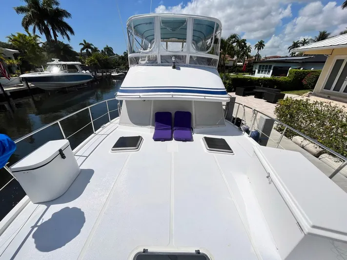 Sea Fever Yacht Photos Pics 1987 Symbol 44 Sun Deck MK II yacht with spacious deck and purple lounge chairs.