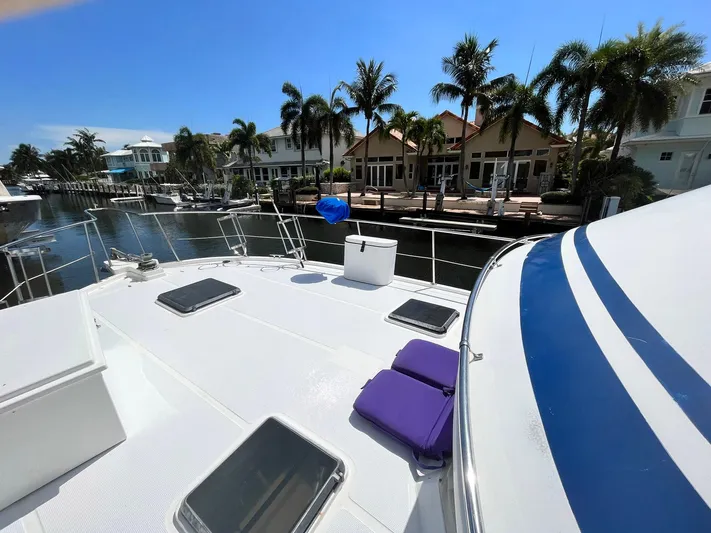 Sea Fever Yacht Photos Pics 1987 Symbol 44 Sun Deck MK II yacht docked, featuring spacious deck and waterfront view with palm trees.