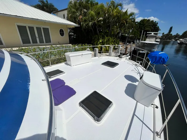 Sea Fever Yacht Photos Pics 1987 Symbol 44 Sun Deck MK II yacht docked by a waterfront home.