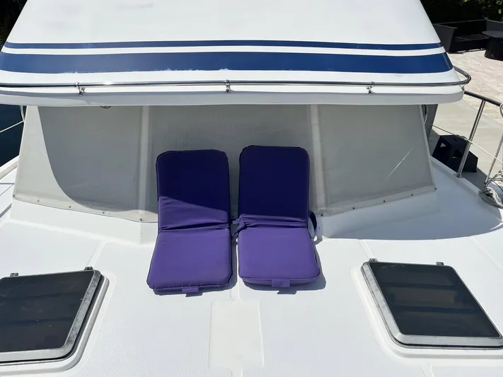 Sea Fever Yacht Photos Pics 1987 Symbol 44 Sun Deck MK II with purple sun loungers on deck.